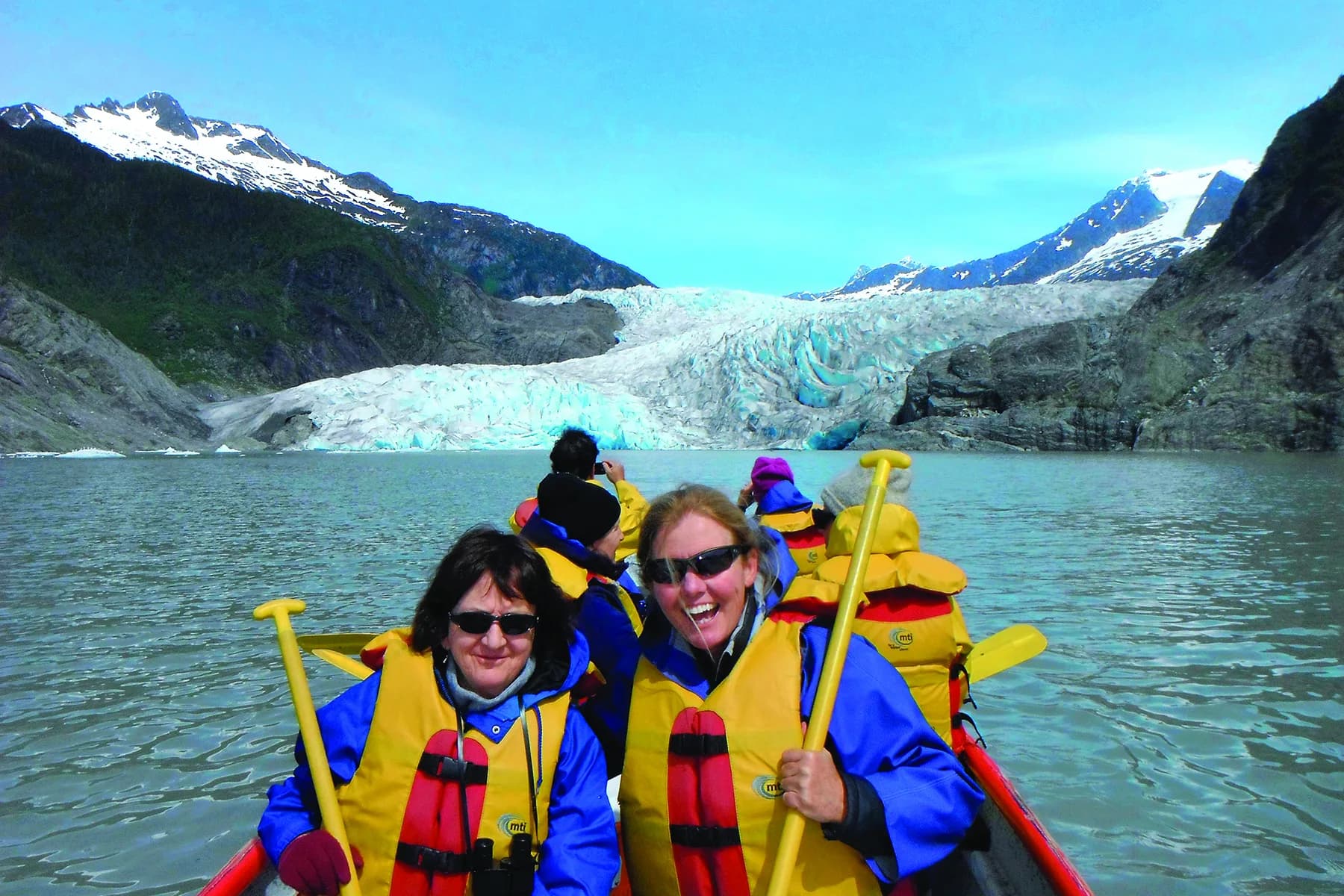 Guests kayaking in front of Mendenhall Glacier near Juneau, Alaska